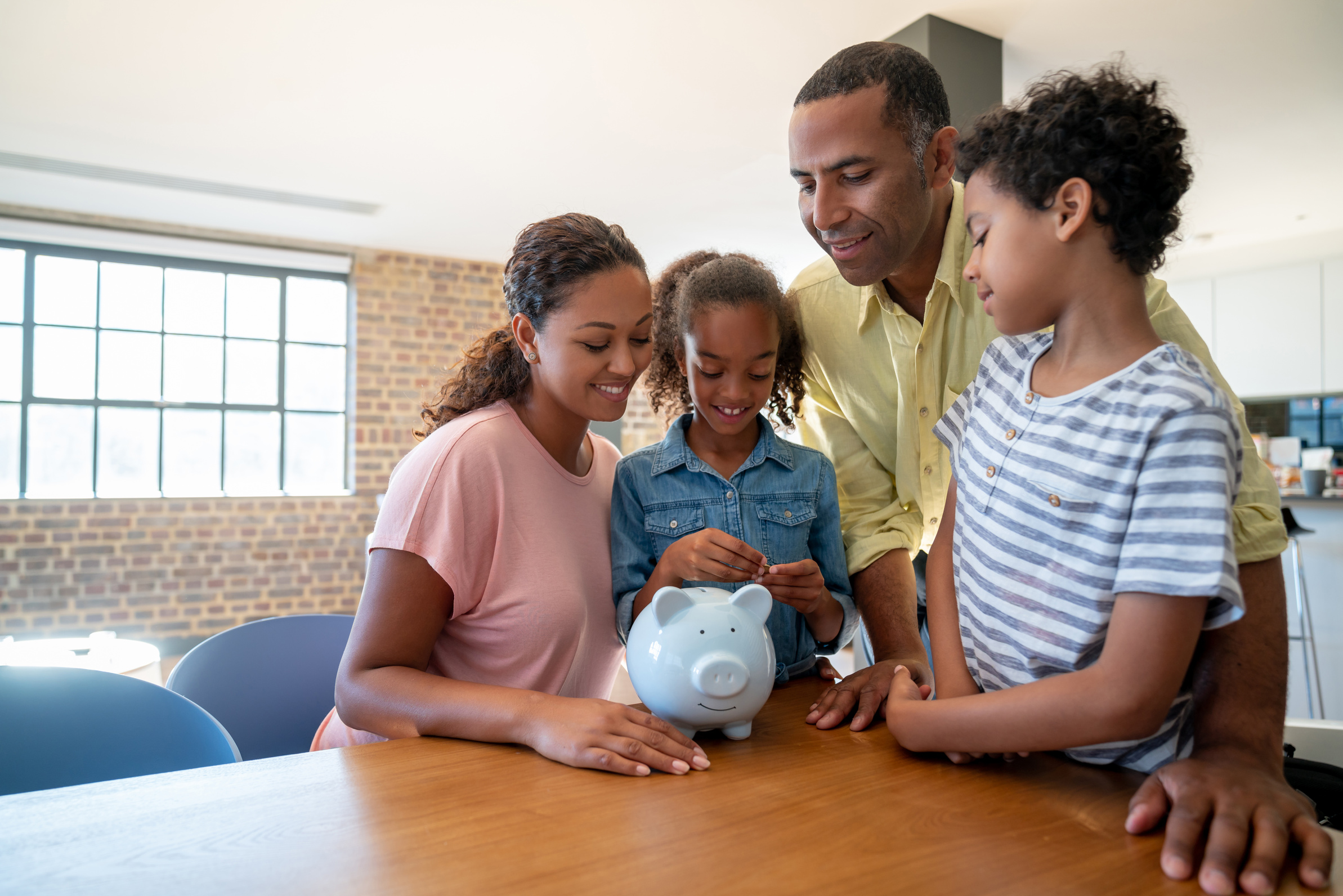 Family saving money in a piggybank